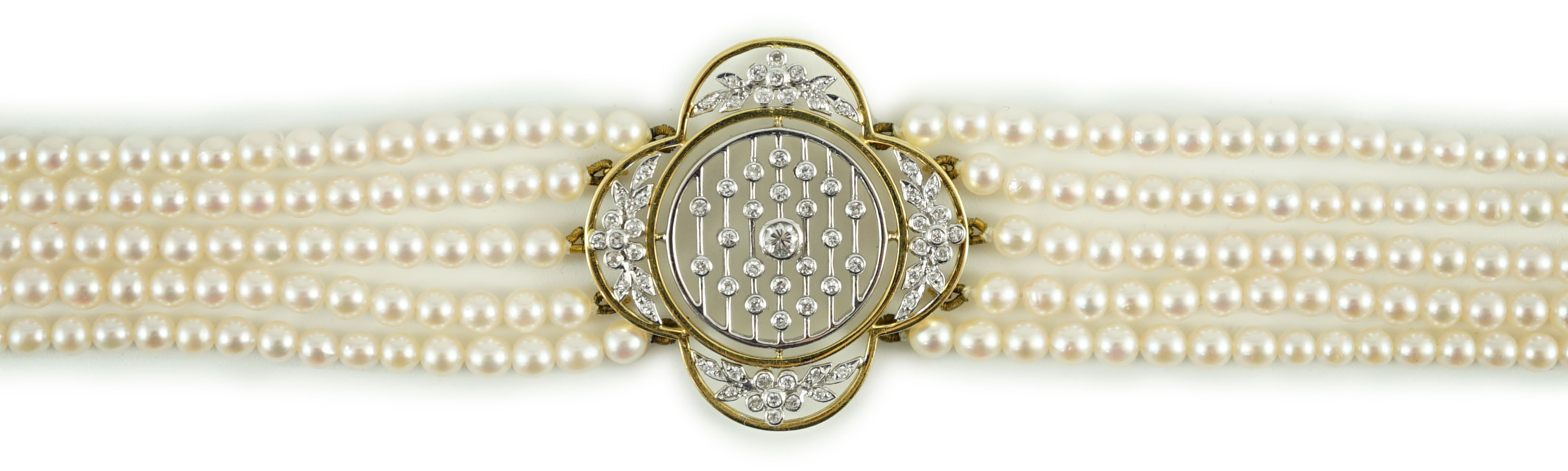 A quintuple strand seed pearl choker necklace, with pierced gold, platinum and diamond cluster set quatrefoil shaped clasp
